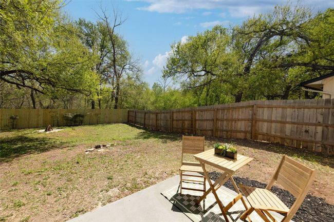 View of yard featuring a fenced backyard and a patio area | Image 26