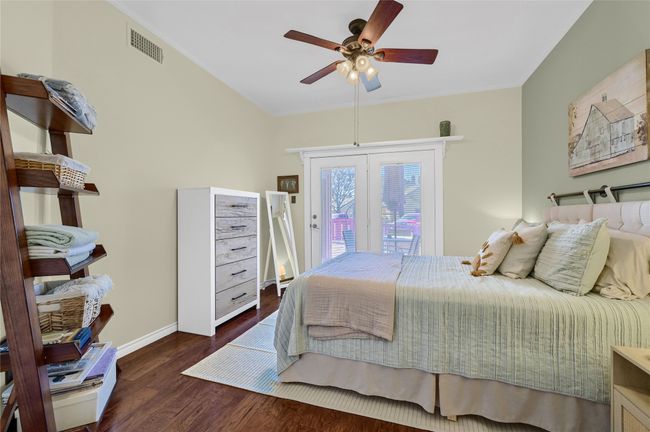 Bedroom with access to exterior, wood finished floors, baseboards, a ceiling fan, and french doors | Image 18