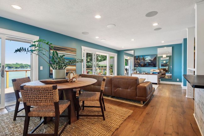 The open floor plan offers the ideal amount of space to right-size your life on the lake. Wide plank wood flooring throughout the main level is both easy care and beautiful. | Image 10