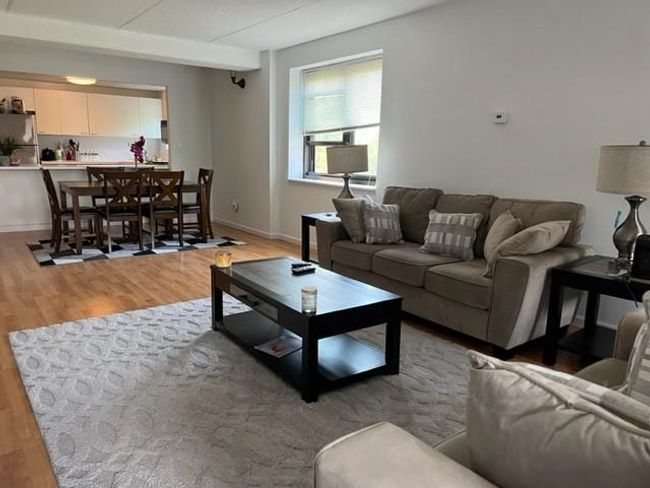 Living area featuring baseboards and light wood-style floors | Image 9