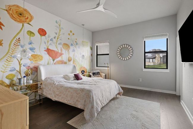 Bedroom with ceiling fan, baseboards, and wood finished floors | Image 33
