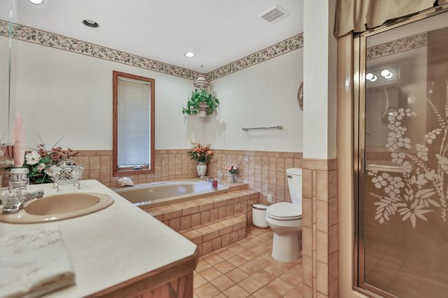 Master bathroom with separate tub and walk-in shower. Ceramic floors and surround. | Image 21