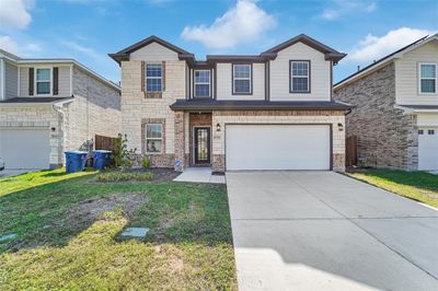 View of property featuring a front yard and a garage | Image 1