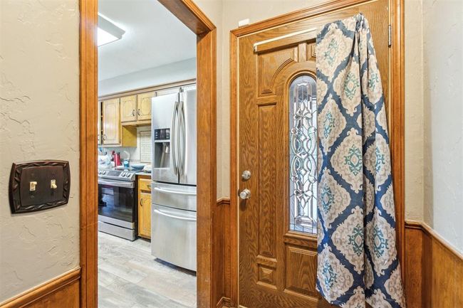 Entryway with light wood-style floors and wainscoting | Image 6