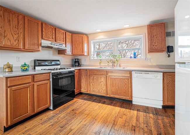 Kitchen with gas stove, sink, dishwasher, and hardwood / wood-style flooring | Image 18