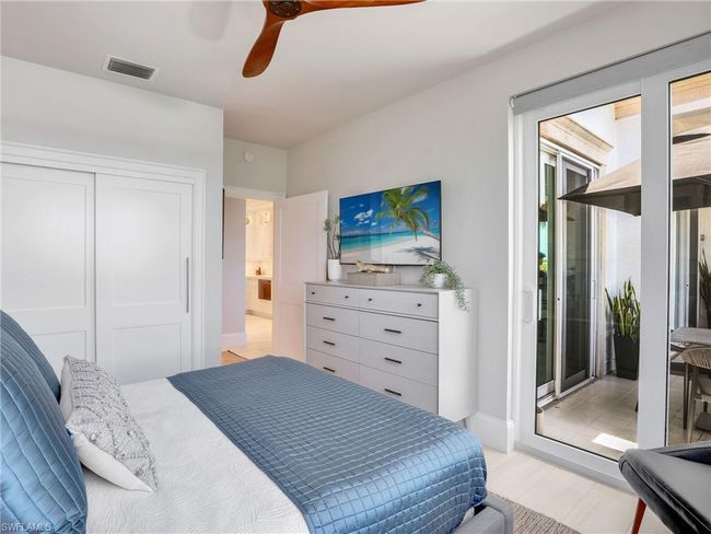 Bedroom featuring access to exterior, ceiling fan, a closet, light wood-style floors, and baseboards | Image 24