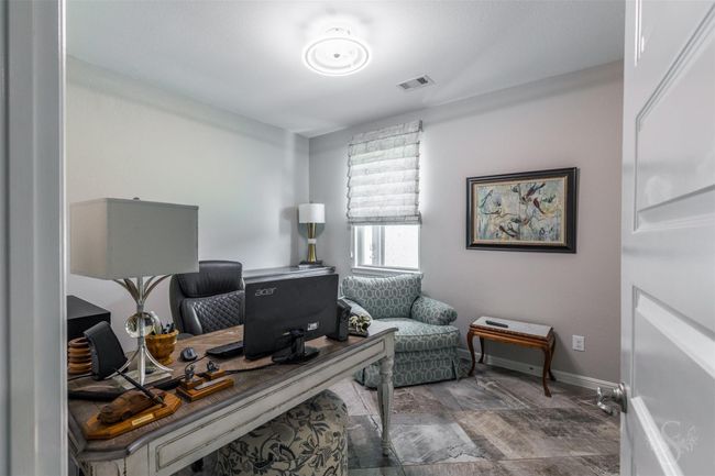 The office includes a glass door for the closet, offering a modern aesthetic. Upgraded blinds enhance privacy and light control, and a fan replaced in 2024 adds comfort and style to the space. | Image 27