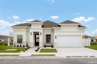 View of front of home with a garage and a front yard | Image 1