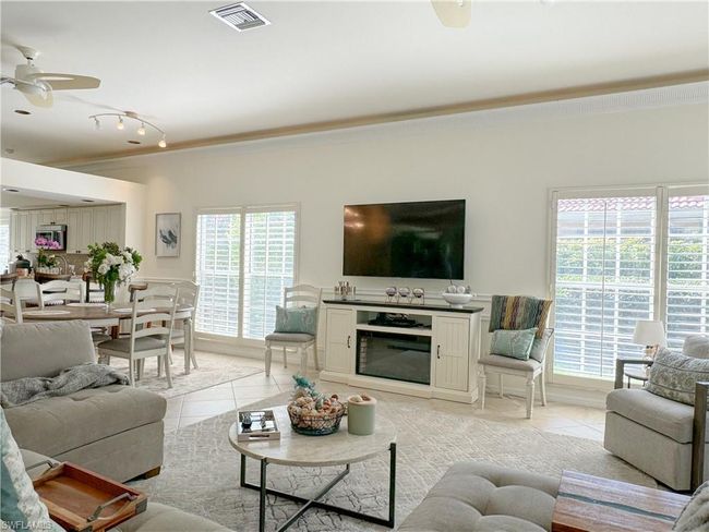 Living room with a healthy amount of sunlight, track lighting, ceiling fan, and light tile floors | Image 28