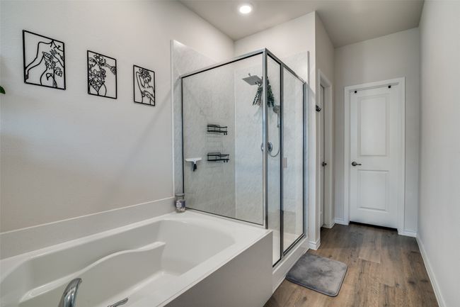 Full bathroom with a bath, a stall shower, and wood finished floors | Image 21