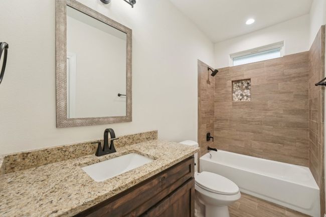 Full bath with toilet, vanity, tile floors, and shower / bathing tub combination | Image 27