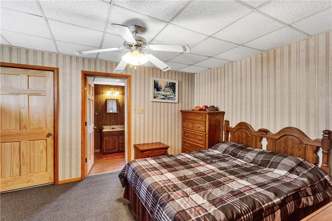 Located on the 1st floor, this bedroom with a full-bath (tub only) is located just off the living room. | Image 20
