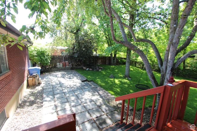 Wooden deck with a patio area and a fenced backyard | Image 6