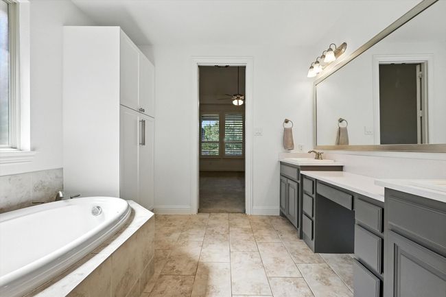 Bathroom with double vanity, a garden tub, and a ceiling fan | Image 19