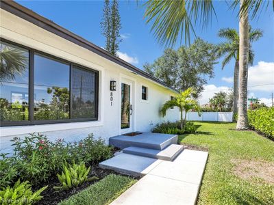 Doorway to property with a lawn | Image 3