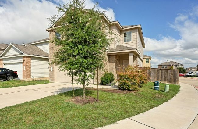 View of front facade featuring concrete driveway and brick siding | Image 24