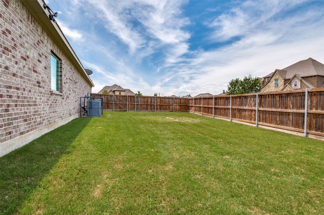 View of fenced backyard | Image 29