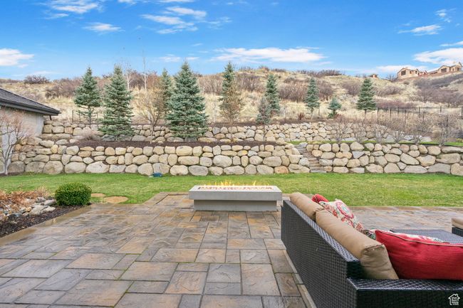 View of patio featuring an outdoor fire pit and fence | Image 113