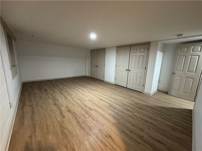 This basement room is ideal for a bedroom with two closets. | Image 18