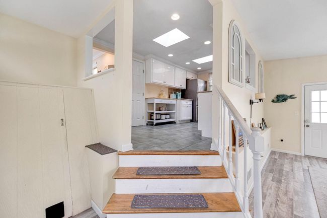 Stairway with recessed lighting, wood finished floors, a skylight, and baseboards | Image 25