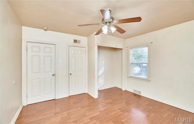 Primary, unfurnished bedroom featuring light wood-type flooring and ceiling fan | Image 9