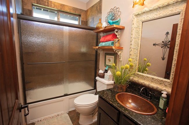 Full bath featuring enclosed tub / shower combo and vanity | Image 16