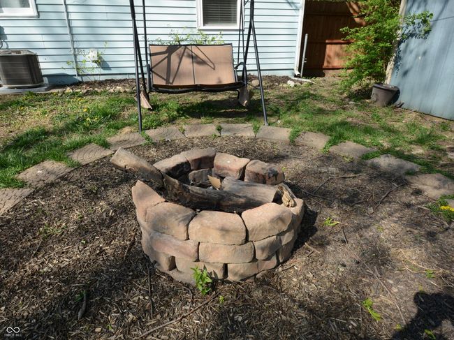 view of yard with a fire pit, fence, and cooling unit | Image 38