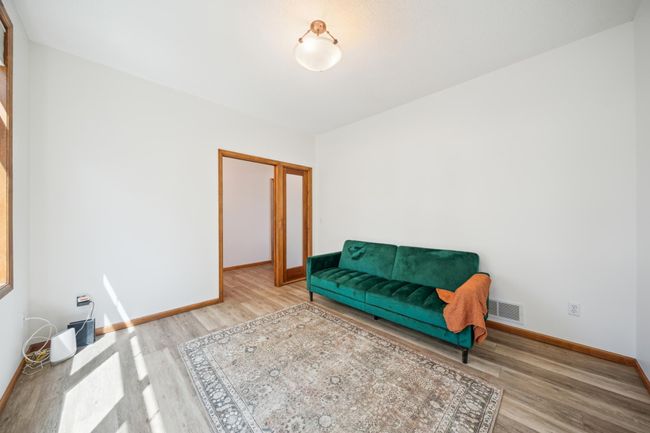 Located on the main level, this versatile room is the ultimate flex space—perfect for a quiet home office, comfortable guest room, home gym, or whatever fits your lifestyle. | Image 19