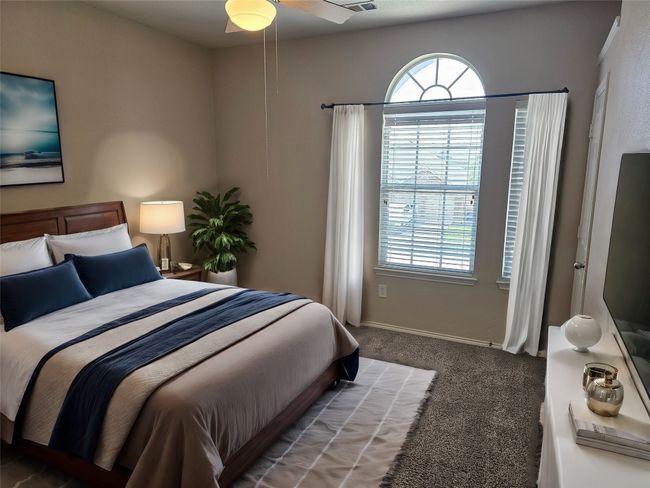 Carpeted bedroom featuring multiple windows | Image 20