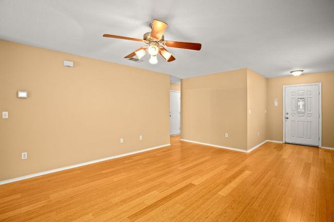 Unfurnished room featuring a ceiling fan, light wood finished floors, and baseboards | Image 5