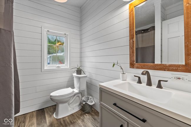 Updated second master bath with a marble counter and waterproof flooring. | Image 26