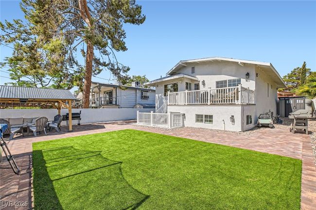 Rear view of house with a patio area, stucco siding, and a gazebo | Image 27