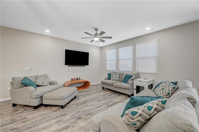 Living room with baseboards, light wood-style floors, ceiling fan, and recessed lighting | Image 12