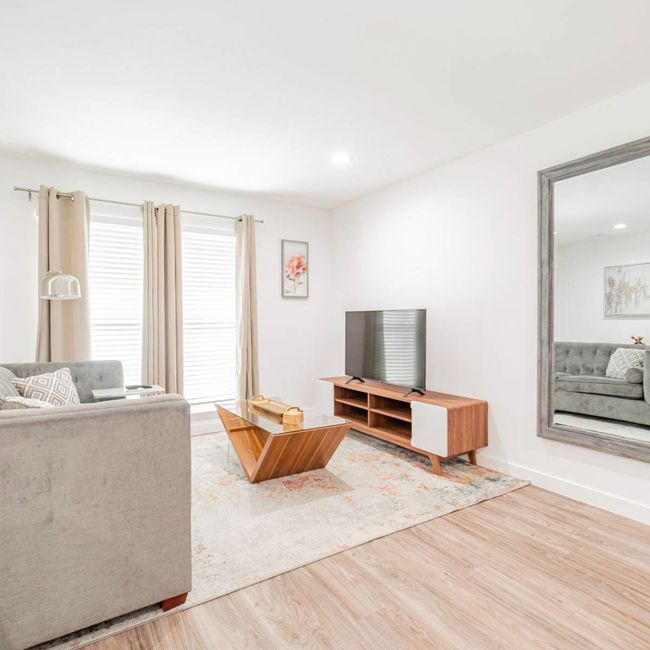 Unfurnished living room with baseboards and wood finished floors | Image 10