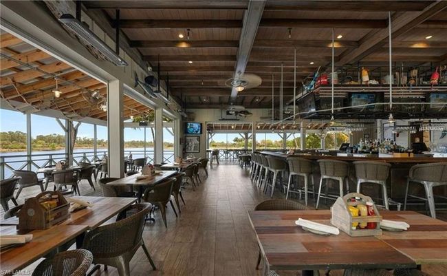 Dining room with hardwood / wood-style flooring, beam ceiling, a healthy amount of sunlight, and wood ceiling | Image 19