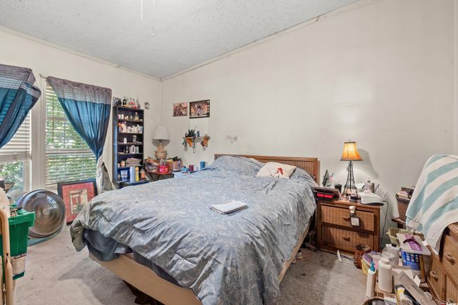 Bedroom featuring carpet, a textured ceiling, and crown molding | Image 21