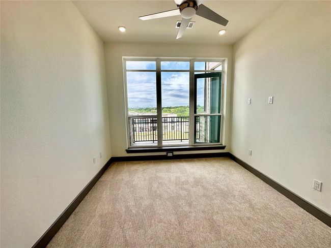 Unfurnished room featuring light colored carpet and ceiling fan | Image 9
