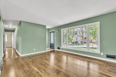 Unfurnished living room featuring hardwood / wood-style floors | Image 3