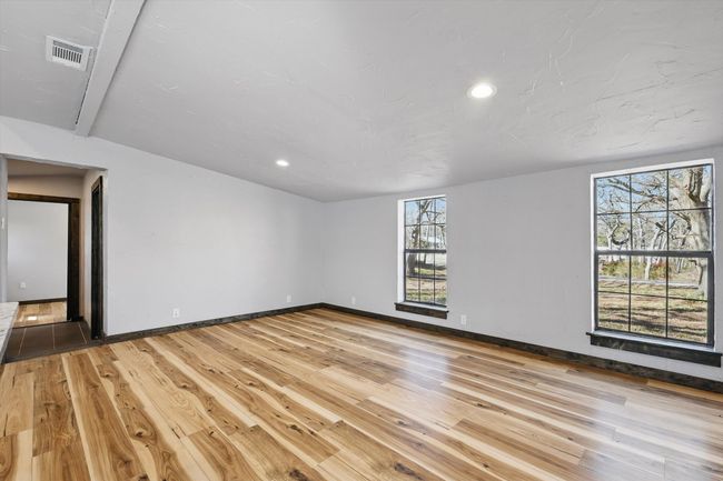 Unfurnished room with light wood-style flooring, recessed lighting, baseboards, and visible vents | Image 5