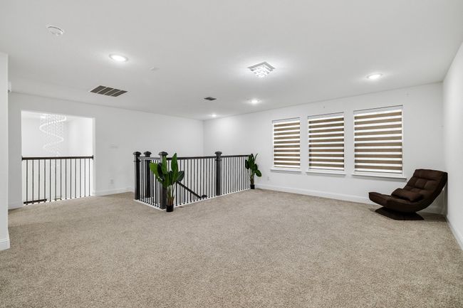 Sitting room featuring light carpet and a notable chandelier | Image 15