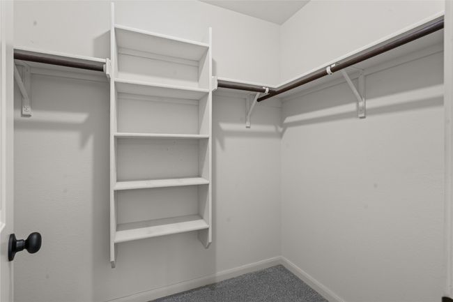 Walk-in closet with plenty of space and storage in the primary bedroom | Image 19