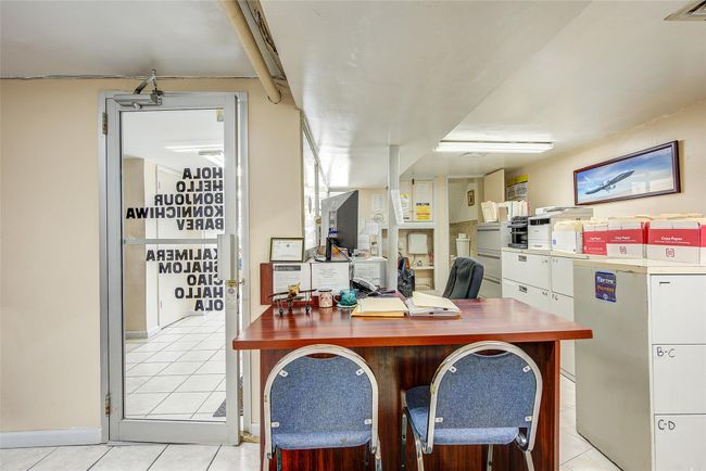 Dining room with light tile patterned flooring and a desk | Image 10