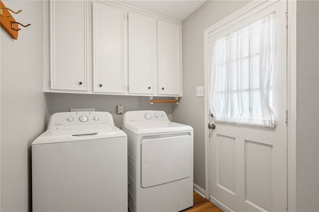 Washroom with washing machine and clothes dryer and cabinet space | Image 19