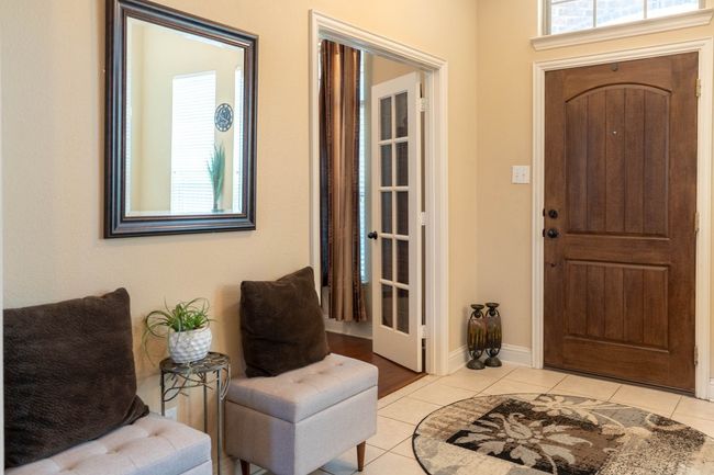 Foyer entrance featuring healthy amount of natural light and light tile patterned floors | Image 4