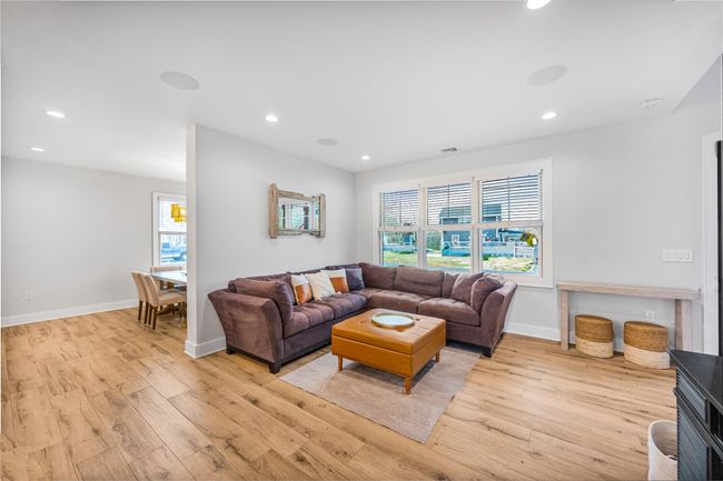 Living room featuring light wood-style flooring, plenty of natural light, and recessed lighting | Image 7