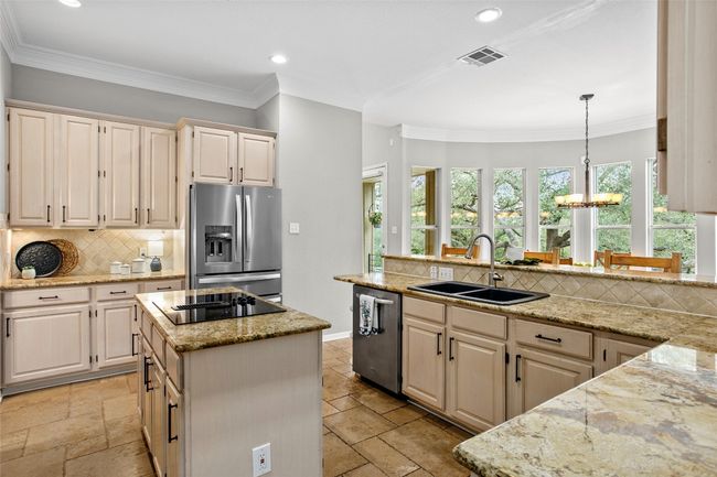 The center island and sink both situate the chef perfectly to take in the beauty of the outdoors | Image 11