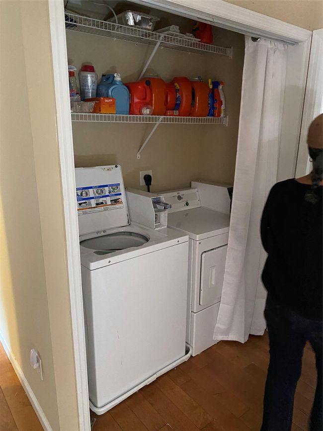 Washroom featuring independent washer and dryer, wood finished floors, and laundry area | Image 17