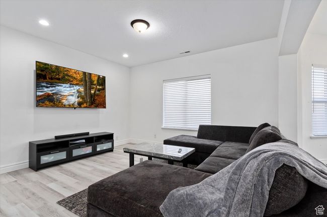 Living room featuring a wealth of natural light and light hardwood / wood-style floors | Image 5