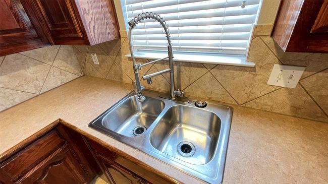 Kitchen view of light countertops and tasteful backsplash | Image 9