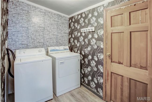 Laundry located off the kitchen with space for stand up freezer | Image 33